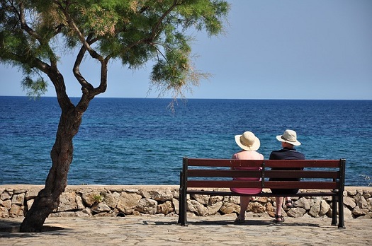 picture of older couple sitting on a park bench
