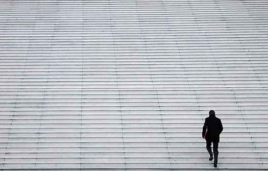 picture of man walking up a column of steps