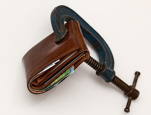 a picture of a vice clamping down on a wallet