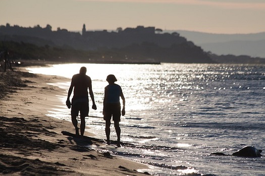 Retired Couple Walking on Beach