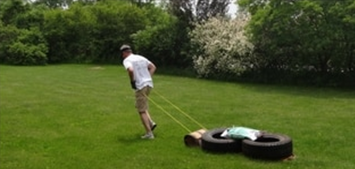 A picture of John dragging the weighted toboggan