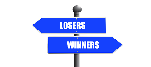 a picture of a sign post indicating the direction for losers and winners