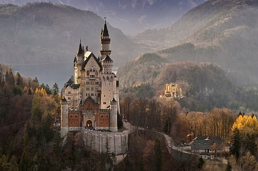 a picture of a castle nestled in European mountains