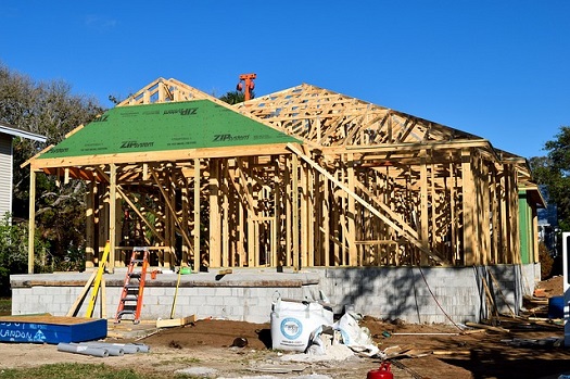 a picture of a residential home in the framing stage of construction